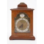 A 1980s mahogany mantle clock, having a drum movement with a lever escapement, in a bracket clock