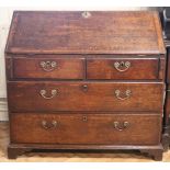 An unusual George III oak fall front bureau, the interior fitted with a strongbox constructed from