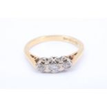 A three stone diamond and 18 ct gold ring, having a central brilliant between two eight-cut diamonds