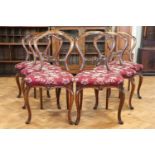 A set of six Victorian carved walnut balloon back dining chairs, having upholstered seats, 87 cm