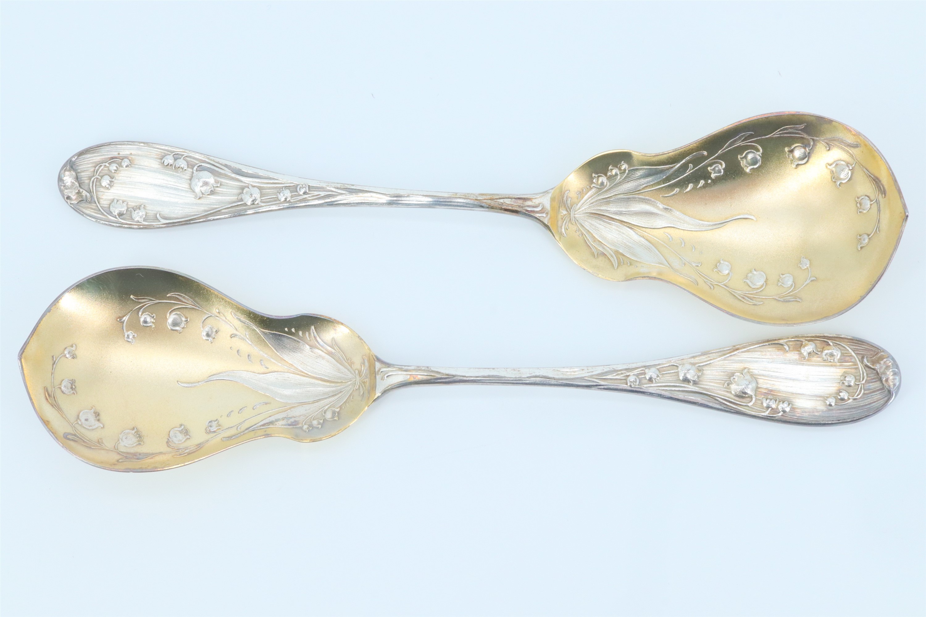 A cased pair of Belle Epoque German silver serving spoons, having pear shaped bowls, decorated - Image 2 of 4