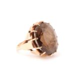 An Edwardian smoky quartz dress ring, the stone being approximately 10 carats and prong set on a