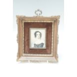 A 20th Century portrait miniature on celluloid of an early Victorian young woman with ringlets and