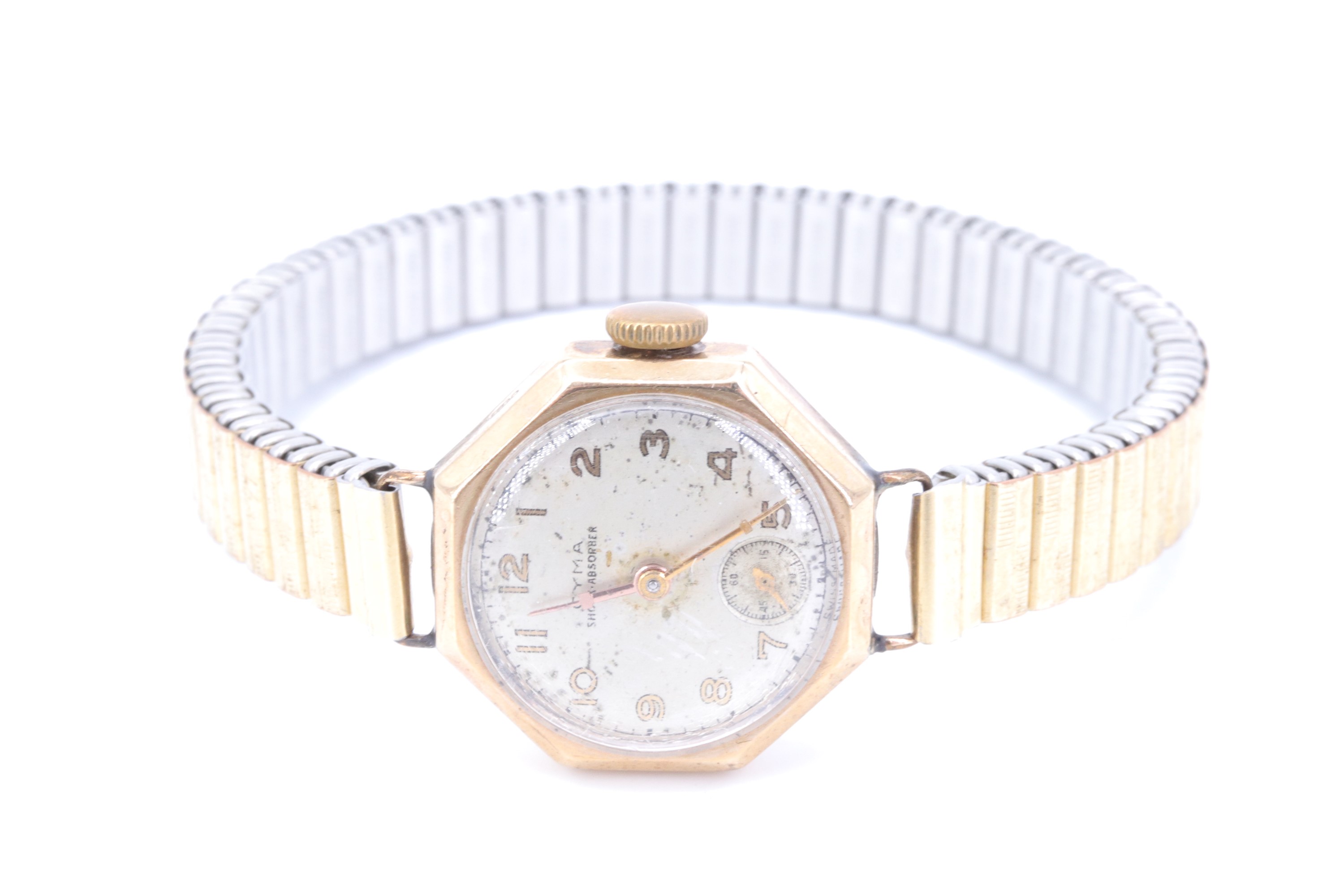 A Cyma 9 ct gold wristlet watch, having a 15 jewel shock-absorber movement, the silvered dial having