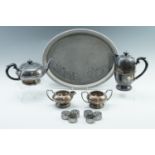 A four-piece electroplate tea set together with a tray and six napkin rings