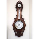 A Victorian carved oak banjo barometer / clock, comprising an aneroid barometer and a thermometer,