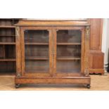 A Victorian inlaid walnut display cabinet, having a cavetto-moulded top over glazed doors on a