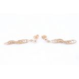 A pair of late 20th Century 9 ct gold earrings, each being a length of partially textured loose rope