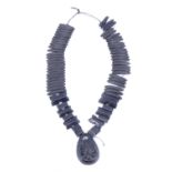 A Victorian faux jet mourning necklace comprising a broad collar of lenticular bars with teardrop