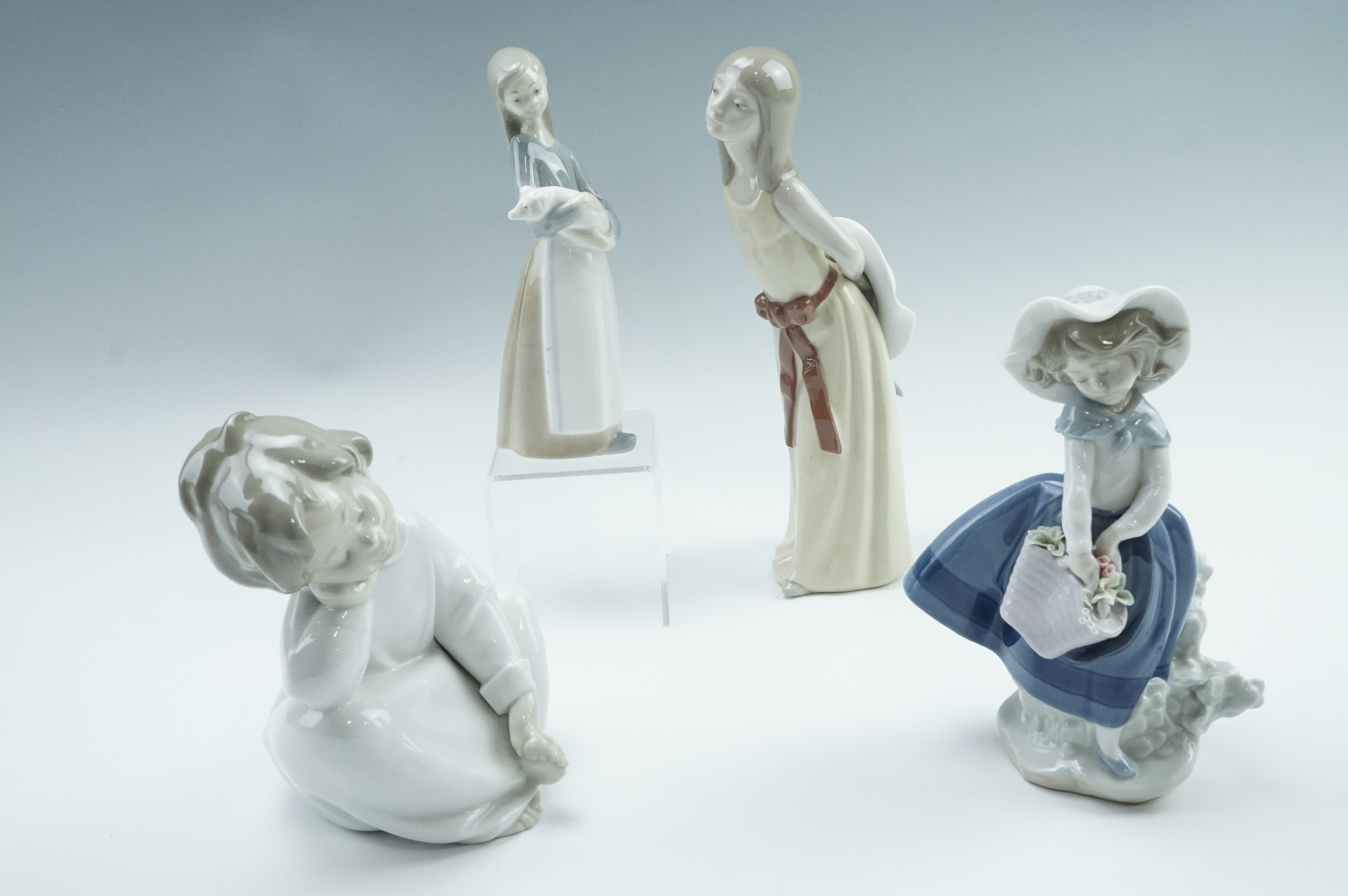 Four Lladro figurines, comprising a girl with a pig etc, tallest 25 cm