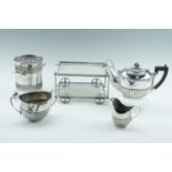 A three-piece electroplate tea set together with a bottle holder and miniature trolley, 27 cm x 18