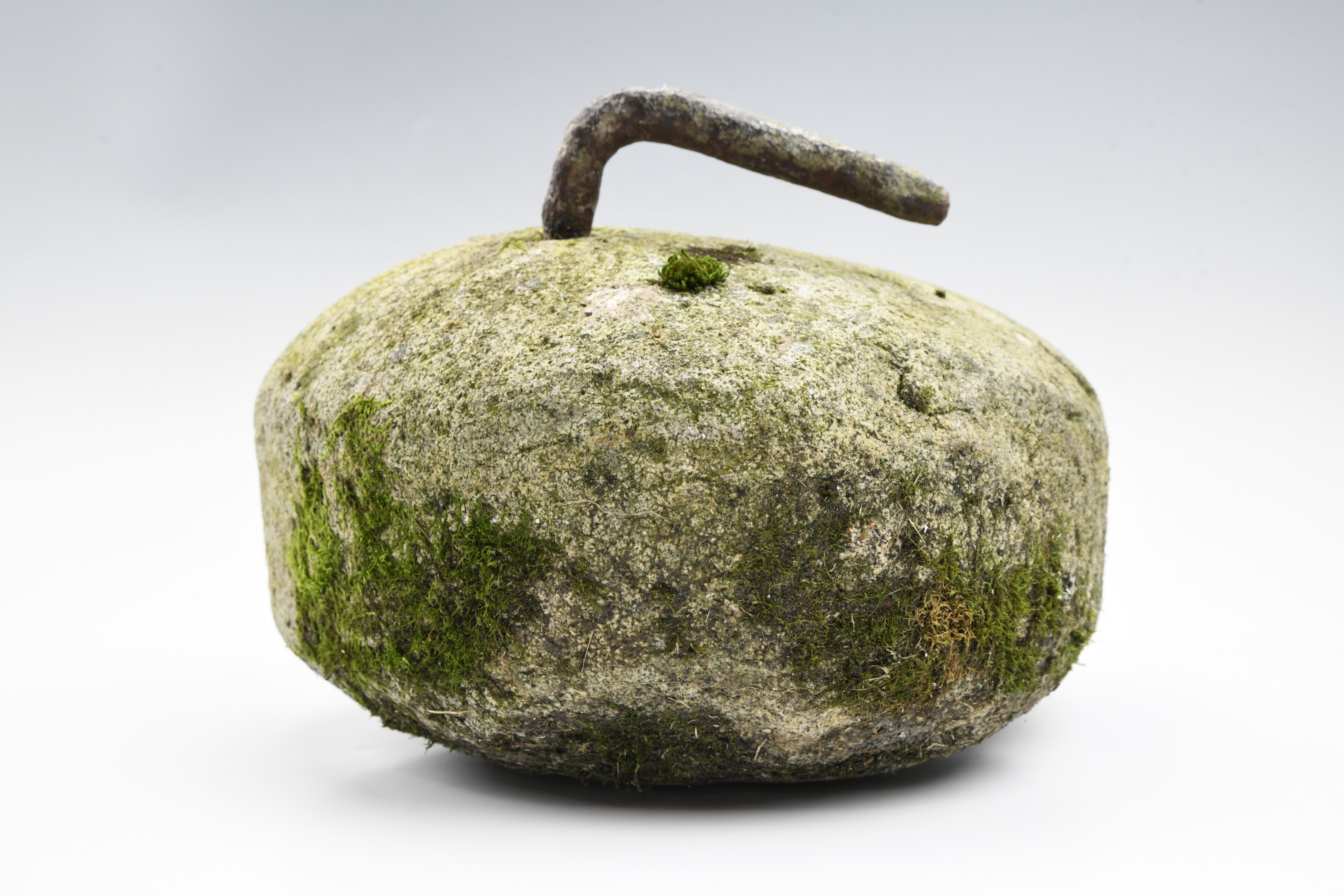 A vintage rustic granite and wrought iron curling stone, 24 x 28 cm