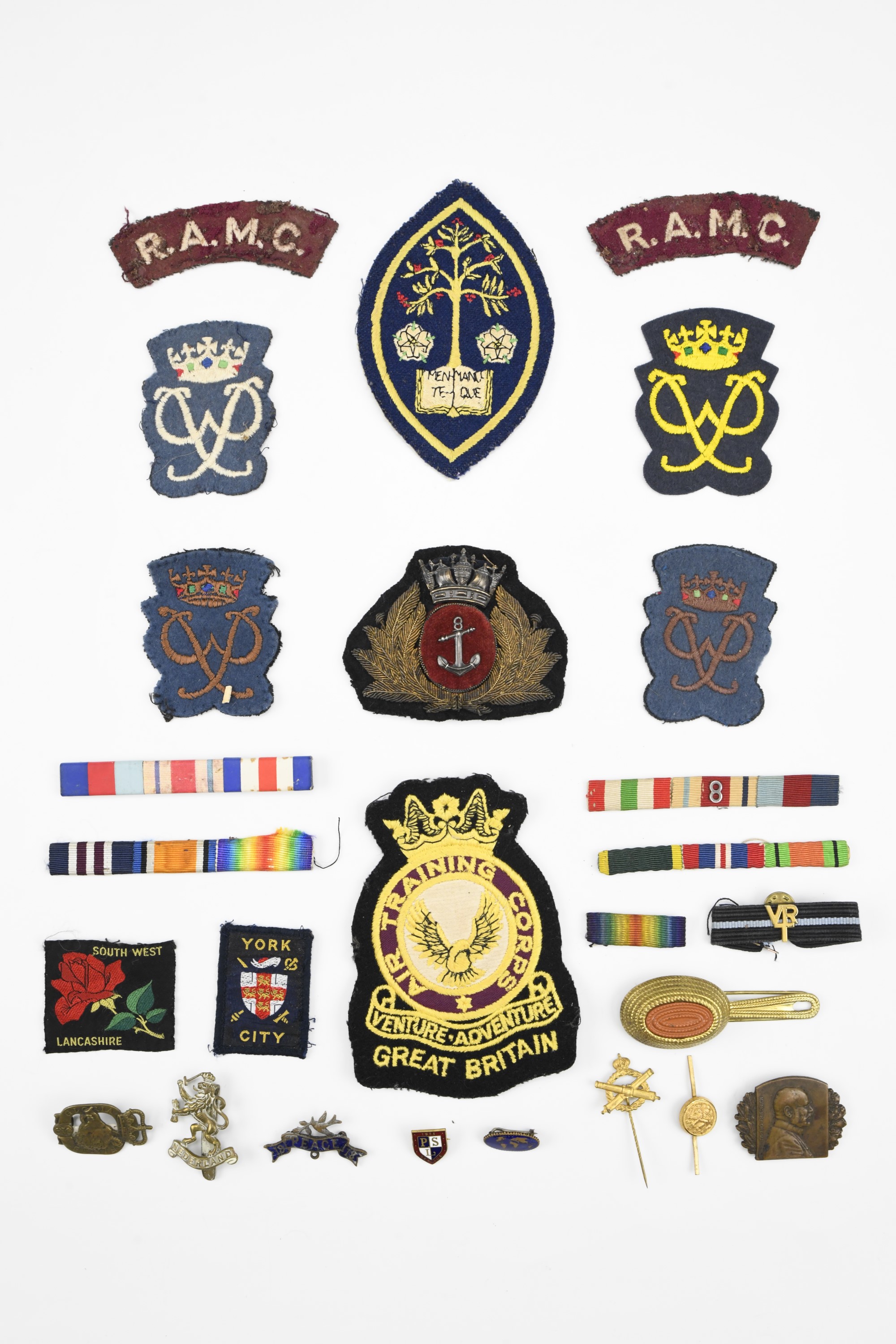 Sundry items of insignia including a Merchant Navy officer's cap badge, a Second World War Dutch