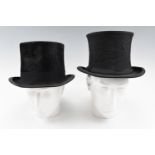 An early 20th Century silk top hat together with an opera hat, both by G A Dunn & Co of London,