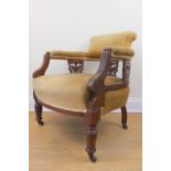 An Edwardian carved walnut plush upholstered bow back arm chair, 75 cm high