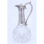 A Victorian white metal mounted heavy cut glass claret jug, of pronounced baluster form, lid
