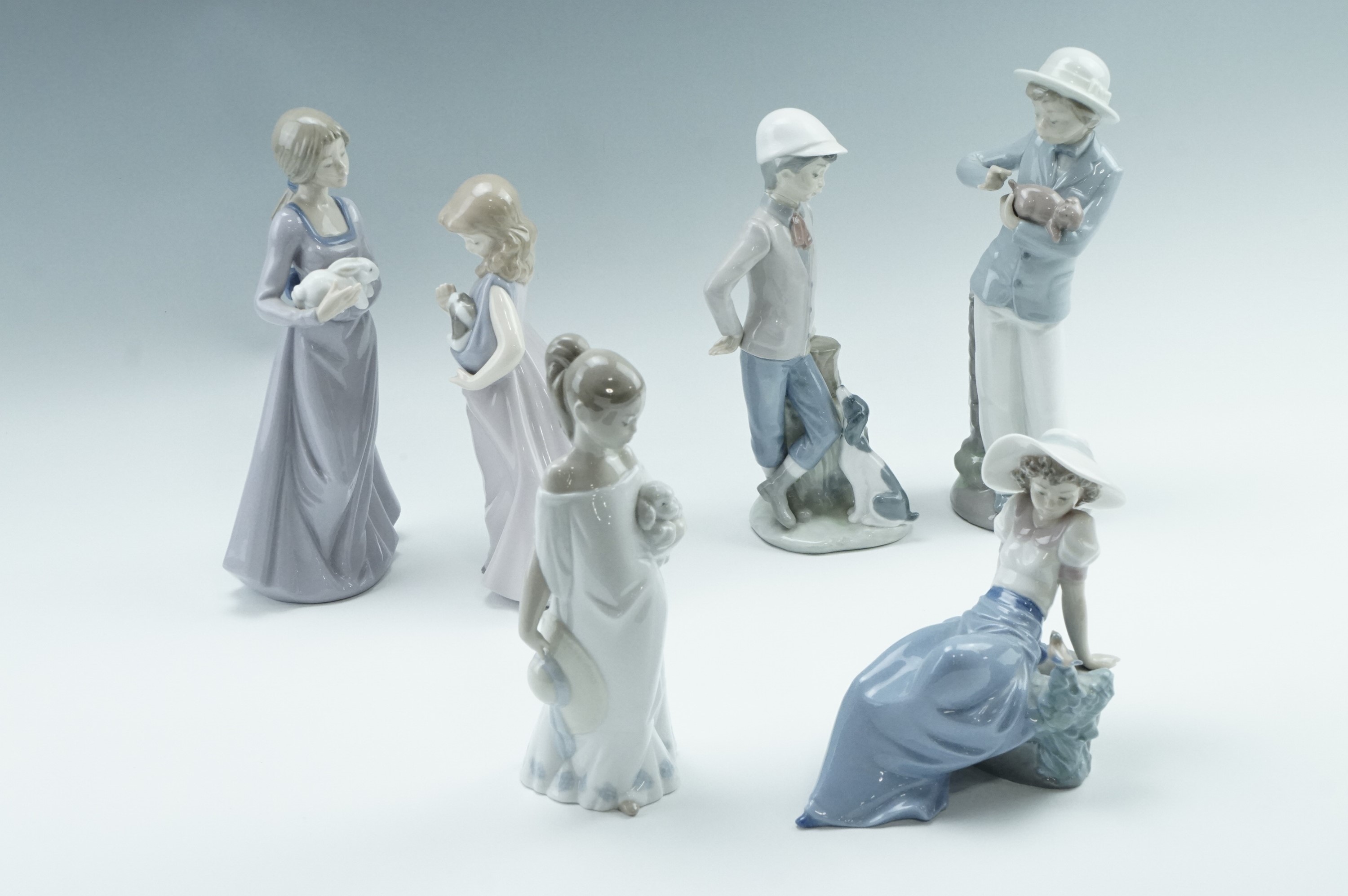 Six Nao figurines, comprising a girl with rabbit, a girl with puppy, etc, tallest 25 cm