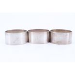 A trio of 1930s heavy silver napkin rings, of oval section and bearing the engraved initial H,