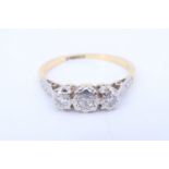 A vintage three stone diamond and 18 ct yellow metal ring, having three illusion set eight-cut