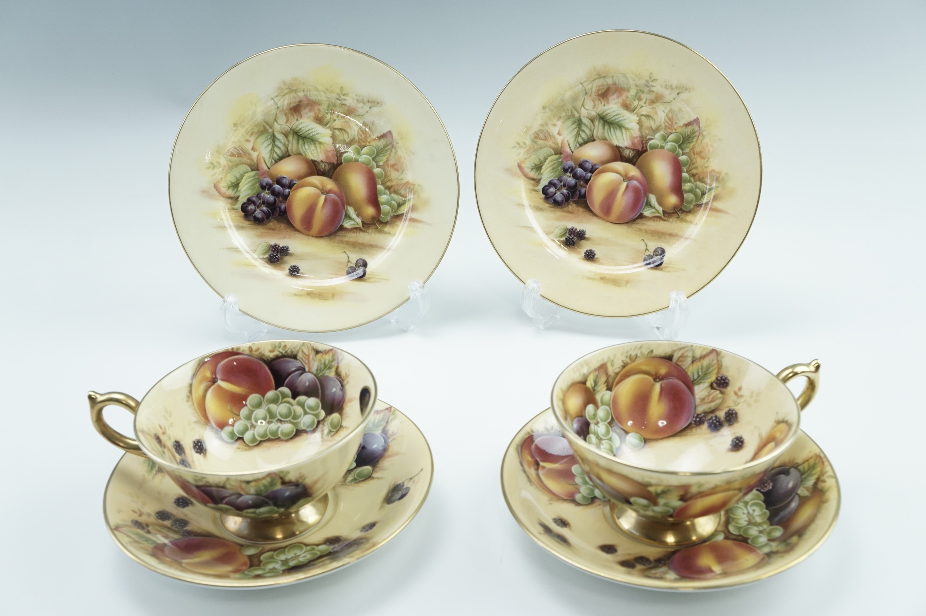 Two Aynsley Orchard Gold tea trios, transfer decorated with fruit, late 20th Century, cup 10.5 x 6