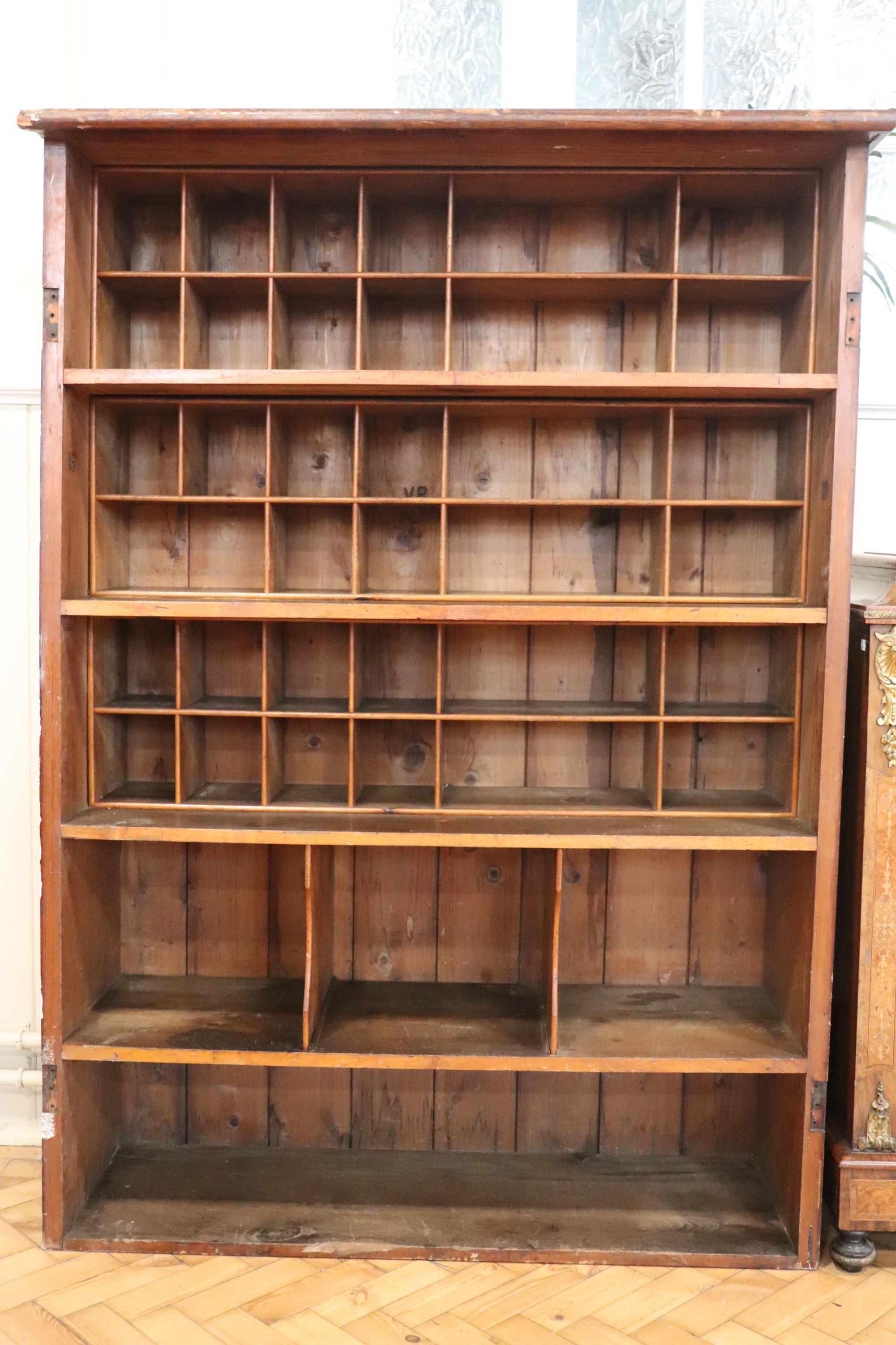 A Victorian pitch pine Post Office sorting room cabinet, lined with varying sizes of pigeon holes,