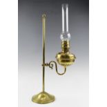 A late Victorian adjustable brass reading oil lamp, having a brass bodied lamp with a single 1 1/