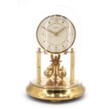 A 1960s Bentima torsion clock, having a glass dome, key present, 17.5 cm, [running when