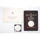 A boxed 1976 silver proof Turks and Caicos Islands 50 Crowns coin and book, together with a 1977
