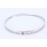 A British Museum silver "Mobius strip" bangle inscribed with a Buddhist Metta prayer "May all beings