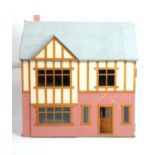 A dolls house and contents, together with a sperate garage, dining room, etc, main building 65 x