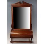 An Edwardian mahogany bathroom wall mirror, having a storage compartment with hinged lid over a