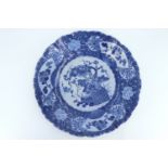 A late 19th Century Japanese blue and white brocade pattern charger, having a scalloped edge and