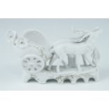 An early 20th Century German bisque wedding cake decoration, having two deer pulling a buggy,