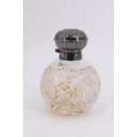 A millennium silver mounted cut glass scent bottle, having a hinged embossed lid enclosing a