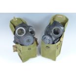 Two British army lightweight gas masks and haversack