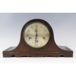 A 1940s oak "Napoleon hat" mantle clock, having a platform escapement and striking and chiming on