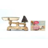 A set of vintage cast iron kitchen scales together with nesting weights and a 1950s Tala icing