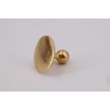 A vintage yellow metal shirt stud marked '18', (tested as high carat gold), front 6.5 mm diameter,