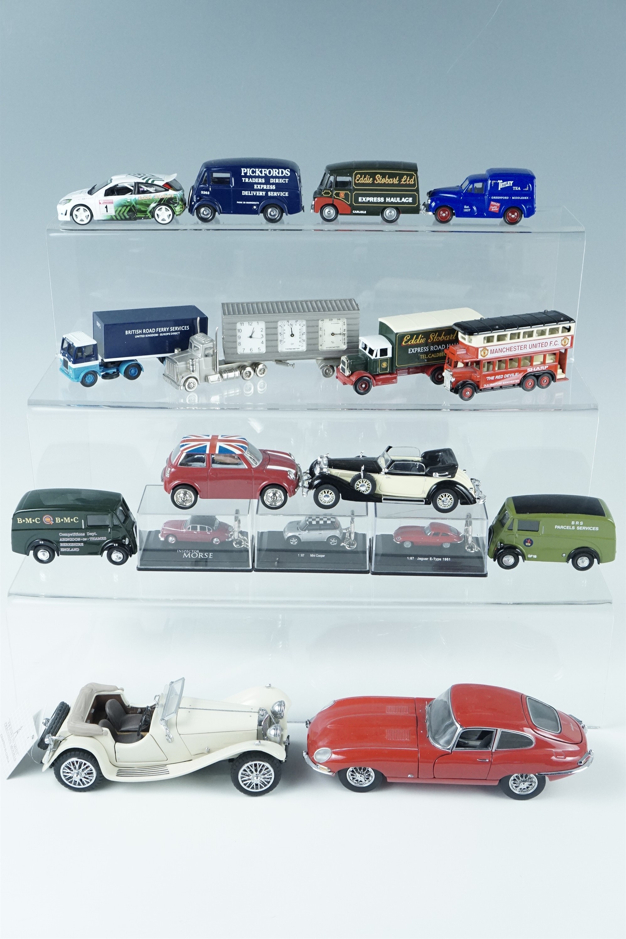 Various Corgi and other diecast vans including a Ford Focus WRC, a Jaguar E-Type, a wagon clock etc