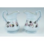 A pair of Victorian Ridgway relief-moulded, floral-enamelled and gilt enriched jugs, impressed