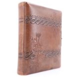 A Victorian tooled leather cartes de visite album having lithographic leaves, containing cabinet