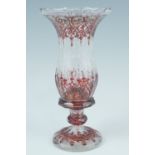 A Bohemian faceted glass vase, having white and ruby hand enamelled decoration, third quarter 19th