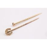 A vintage seed pearl set yellow metal stick pin, its terminal in the form of a horse shoe,