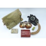 A Second World War British army GS gas mask with anti-gas ointment, goggles and anti-dim compound