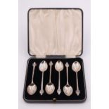 A cased set of six silver coffee spoons, having adorsed geometric terminals, W H Haseler Ltd,