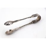A pair of Victorian silver bow sugar tongs, the cast legs having twisted centres and floral and