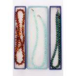 Three late 20th Century hardstone and amber necklaces, comprising two necklaces variously of