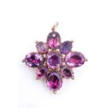 A Georgian amethyst and yellow metal pendant / brooch, the central brilliant cut stone surrounded by