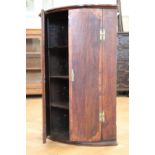 A late Georgian mahogany-cross-banded oak bow-fronted hanging corner cabinet, 62 cm x 90 cm