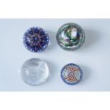 Four glass paperweights, including Selkirk Glass and Edinburgh Crystal examples